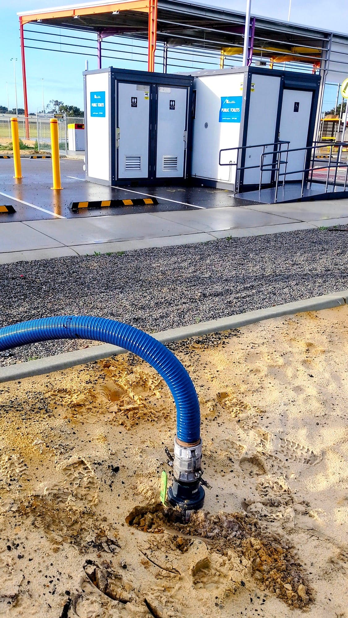 Pump out hose connected at a site toilet block