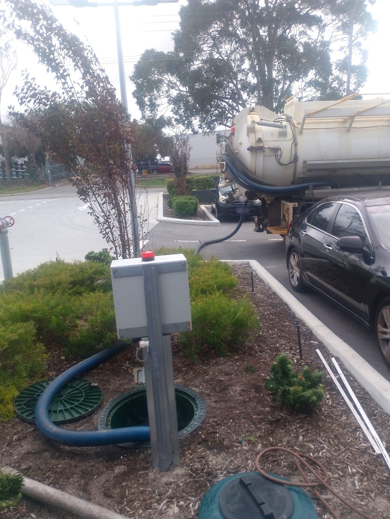 Vacuum truck pumping out an on-site waste water treatment system